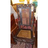 An early Georgian carved oak armchair, with acorn finials, barley twist supports, having cane seat