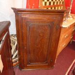 A Georgian oak corner cabinet