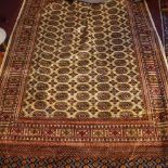 A Bokhara style carpet, with elephant pad motifs on a beige ground, contained by geometric border,