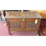 A 17th century oak coffer, with two carved panels and border, H.61 W.97 D.48cm