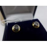 A pair of 18ct gold and diamond stud earrings, approximate combined carat of 0.35