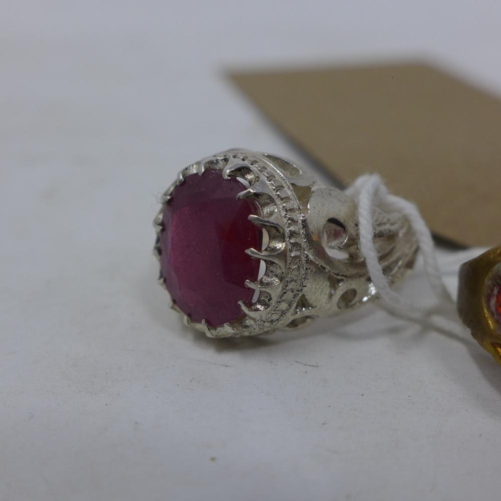 A brass and garnet graduation ring, together with a gilt metal ring inset with two rubies and anchor - Image 3 of 3