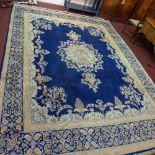 A Central Persian Kirman carpet, central floral medallion on a sapphire field complimented by a