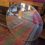 An early 20th century circular mirror, with bevelled glass plate, decorated with flowers, Diameter