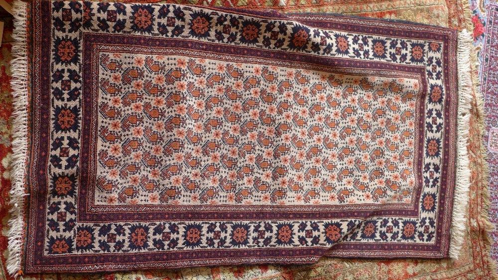 A Baloush rug, with central geometric motifs, on a beige ground, contained by geometric borders,