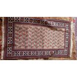 A Baloush rug, with central geometric motifs, on a beige ground, contained by geometric borders,