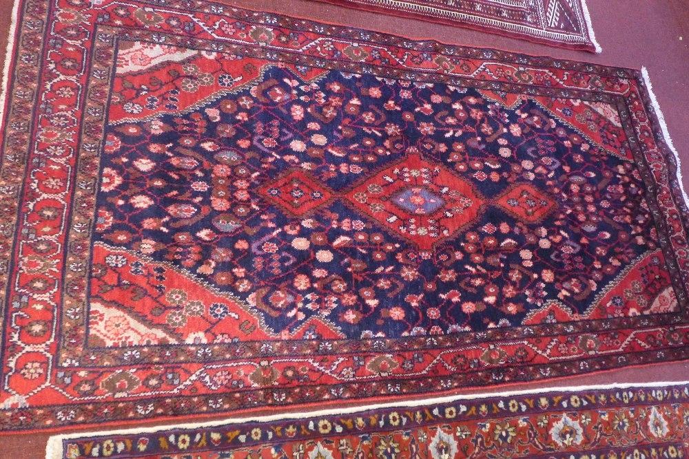 A North West Persian Nahawand rug, central diamond medallion with repeating spandrels on a