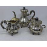 A mid to late 19th century three piece silver tea set, comprising a teapot, twin handled sugar pot
