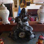 A late 19th century French spelter mantel clock, drum movement, striking bell, the case with