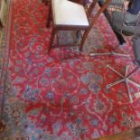 A large Kashan carpet, with central floral medallion on a red ground, contained by floral swags