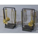 A pair of polished brass cocktail bar sets, black steel frame, slate base