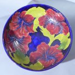 A Moorcroft bowl, decorated with flowers, stamped Moorcroft and signed WM to base, Diameter 26cm