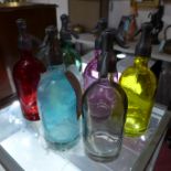 A set of six multi colored glass soda siphons