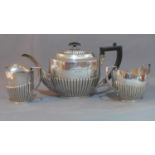 A three piece silver plated tea set, comprising a teapot with Bakelite handle and finial, a twin