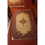 An early 20th century Persian kilim, with central floral medallion on cream ground, multi-