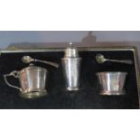 An early 20th century Art Deco style silver set of salts with pepperette and spoons, glass liners,