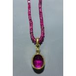 A tourmaline beaded necklace, with 18k yellow gold pendant inset with cushion cut tourmaline,