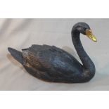 A contemporary black fibreglass model of a swan with gilt beak, H.39cm