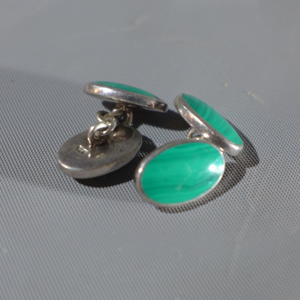 A pair of silver cufflinks, each inset with oval cut malachite, marked 925