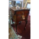 A Georgian style mahogany drop leaf side chest, with three drawers, raised on cabriole legs