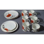 A Wedgwood bone china 'Corn Poppy' part tea service by Susie Cooper, comprising 5 side plates, 4