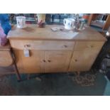 A mid 20th century Ercol sideboard, with two drawers, over three cupboard doors, H.83 W.123 D.45cm