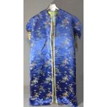 An early 20th century Chinese blue silk Brocade robe, decorated with flora and fauna