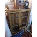 An early 20th century pine bookcase, with two glazed doors, H.141 W.112 D.30cm