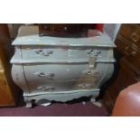 A distressed painted bombe chest, with three drawers, raised on cabriole legs, H.85 W.97 D.48cm