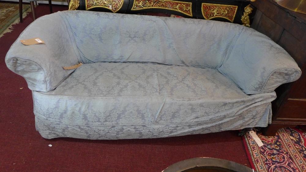 An early 20th Chesterfield sofa, with cream linen upholstery, having blue damask cover, raised on