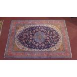 A Kashmiri carpet, central floral medallion, surrounded by floral motifs, on a blue ground,