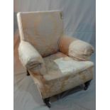 An early 20th century armchair, tapestry upholstery, cream damask cover, raised on turned legs and