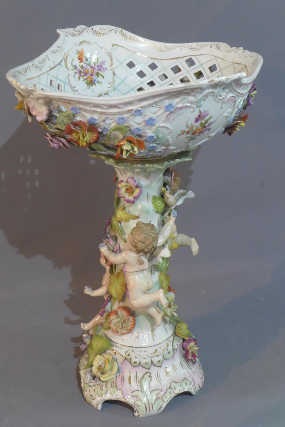 A Meissen style porcelain compote, having pierced bowl decorated with flowers and gilt heightened,