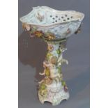 A Meissen style porcelain compote, having pierced bowl decorated with flowers and gilt heightened,