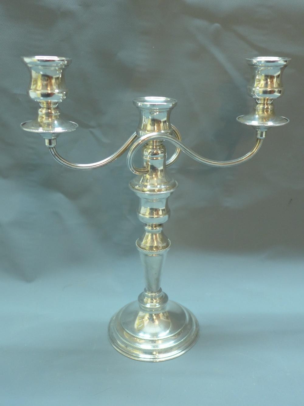 A silver plated two branch candelabra, by G.A. Baker, H.33cm