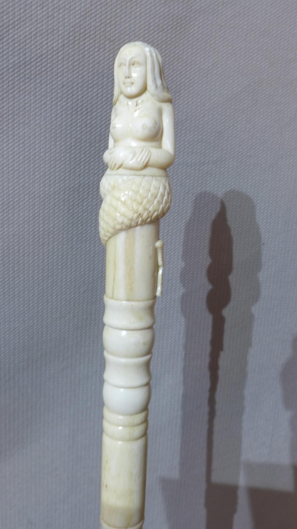 A 19th century carved bone cane with mermaid terminal, with stand - Image 2 of 2