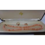A coral and yellow gold necklace, ring and earrings set, the ring being 9ct gold, the clasp of the