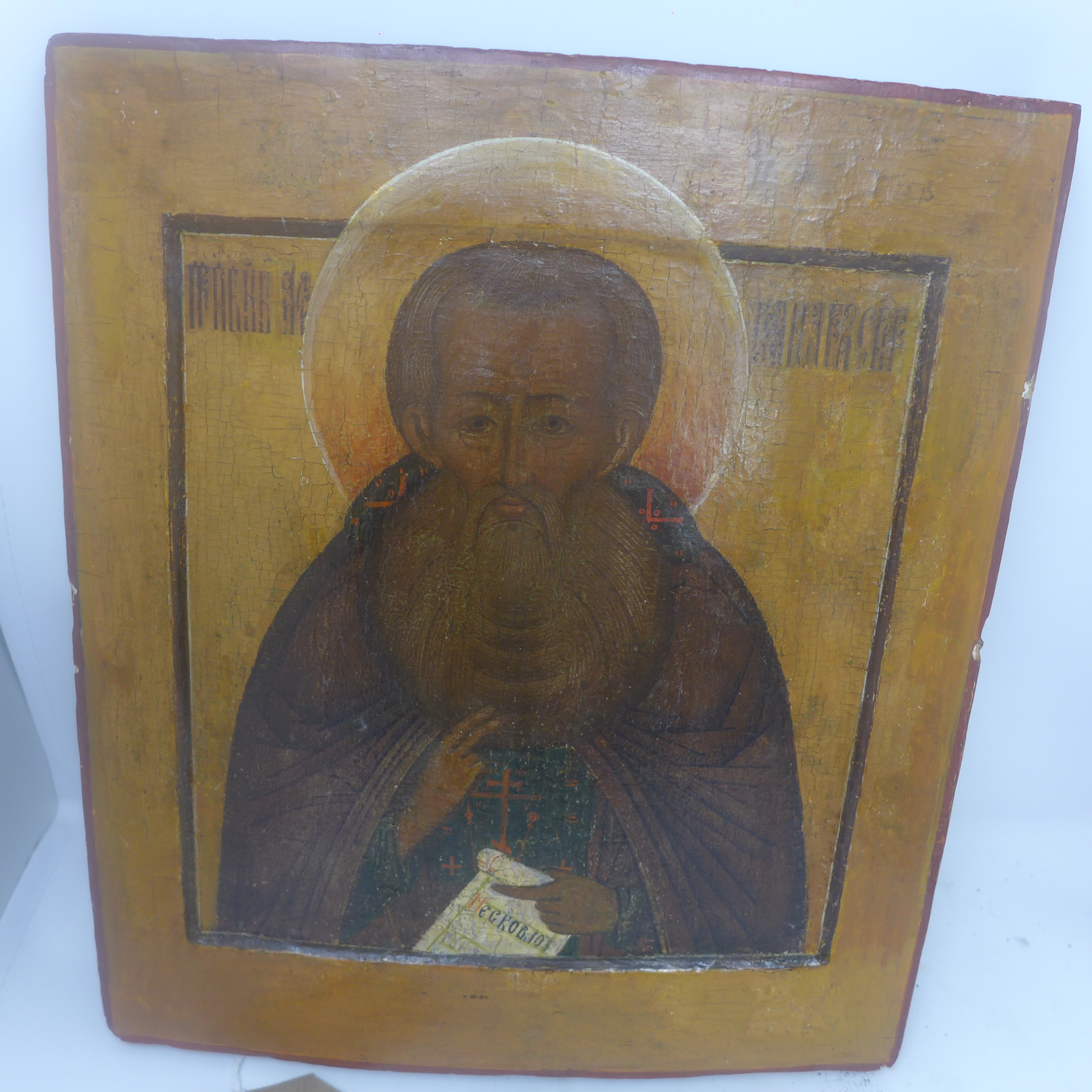 A Russian icon depicting a Saint shown in profile half-length, blessing and holding a scroll of - Image 6 of 8