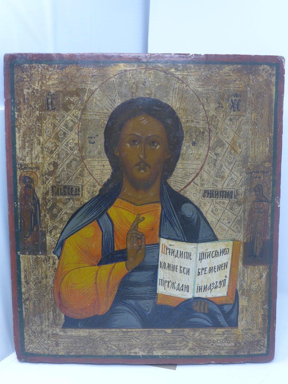 A Russian icon, Christ Pantocrator, painted half-length blessing and holding the open Gospel,