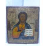 A Russian icon, Christ Pantocrator, painted half-length blessing and holding the open Gospel,