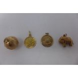 A collection of vintage yellow gold charms/pendants, comprising a globe, stamped 9K, an elephant