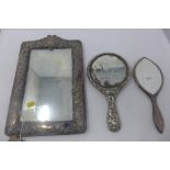 A Victorian white metal mounted easel mirror, decorated with scrolling foliage, vacant cartouche and