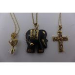 A black Jade yellow gold pendant in the form of an elephant, stamped 14k on a fine gold chain,