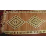 An antique large kilim runner with triple geometric medallion contained by geometric border, 420 x