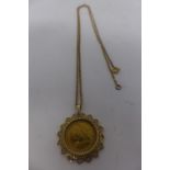 An 1899 half gold sovereign set in 9ct gold pierced heart pendant mount with gold chain stamped