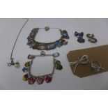 A collection of silver, to include two silver travel enamel shield charm bracelets, having padlock