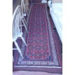 A North West Persian Malayer runner, repeating all over Heratie motifs on a rouge field within