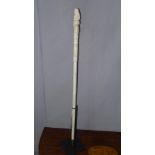 A 19th century carved bone cane with mermaid terminal, with stand