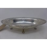 A silver table bowl having pierced fretwork edge, raised on four paw feet, hallmarked London 1946,