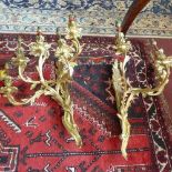 A pair of Rococo style gilt metal five branch wall sconces, with scrolling foliage design, H.65cm (